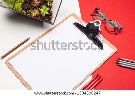 Blank clipboard paper on red and white paper background