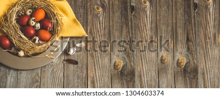 Happy Easter background. Easter eggs in a nest on a metal plate on a wooden background. Quail eggs. Happy Easter concept
