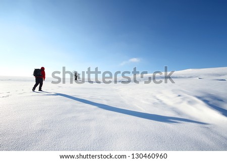 Nature photographer trekking in winter conditions