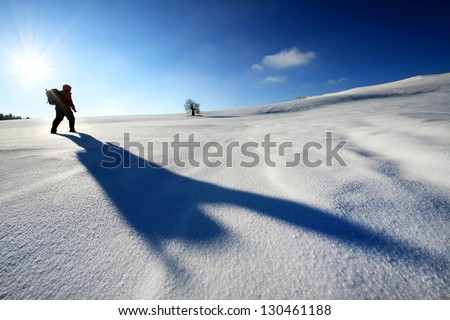 Nature photographer trekking in winter conditions