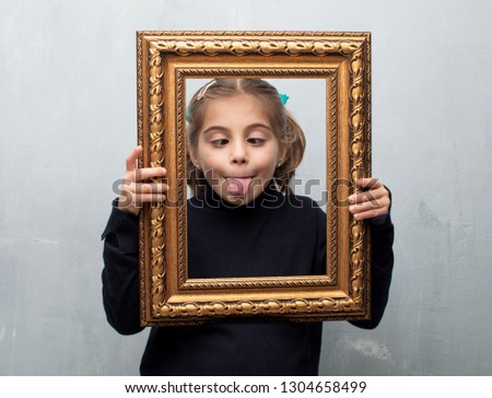 little girl holding a baroque frame