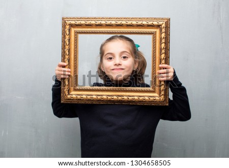 little girl holding a baroque frame