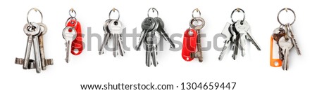 Key ring with house door keys collection isolated on white background. Banner design element security concept Royalty-Free Stock Photo #1304659447