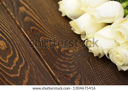 White Rose. A bouquet of delicate roses on a wooden background. Place for text. Romantic background for spring holidays.