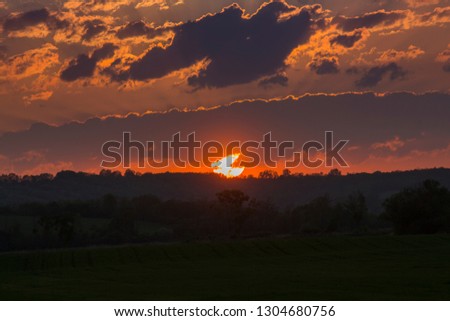 Amazing sunset with sun rays through  the clouds over the forest, deforestation problems in world, beautiful background