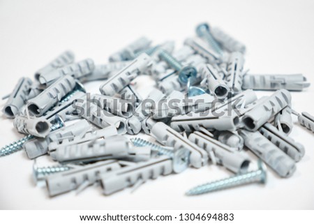 Plastic dowel pin or wall plugs on white background, selective focus