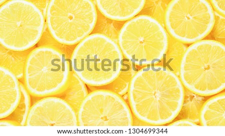 A slices of fresh juicy yellow lemons.  Texture background, pattern. Royalty-Free Stock Photo #1304699344