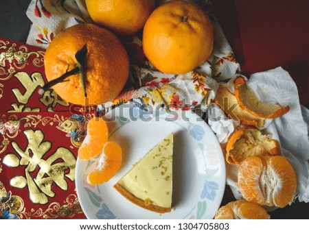 Oranges, red envelopes and greeting Chinese characters are representative items for the national holiday. Chinese texts are telling wishes to earn lots of money and good fortune in the upcoming year.