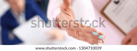 Businesswoman offer hand to shake as hello in office closeup. Serious solution friendly support service excellent prospect introduction or thanks gesture gratitude invite to participate concept