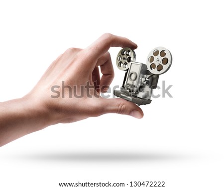 Man's hand holding cinema projector isolated on white background