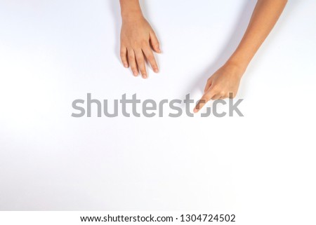 Children hands pointing on white background, top view Royalty-Free Stock Photo #1304724502