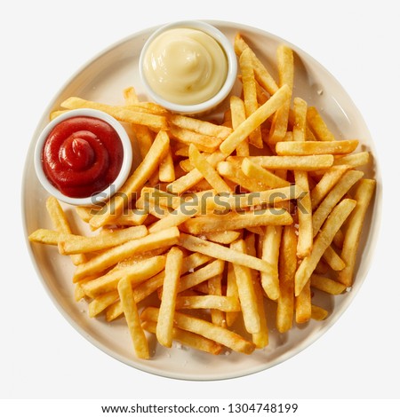 Plate of french fries potatoes served with ketchup and mayonnaise sauces in small bowls, viewed from above isolated on white background Royalty-Free Stock Photo #1304748199