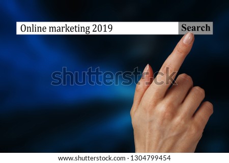 The text in the browser shows "Online marketing 2019". Conceptual photo list of things that are going to become popular in this year. A woman hand shows the terms you should investigate in 2019.