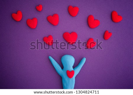 Person with red hearts. Person and Hearts are made out of play clay (plasticine).