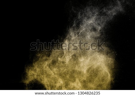 golden powder effect splash for makeup artist or graphic design in black background