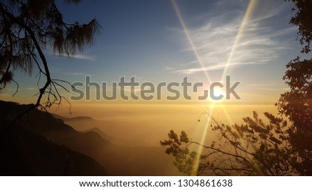 a really amazing and rare sunrise sun and moon combined above the clouds. vattakanal,India.