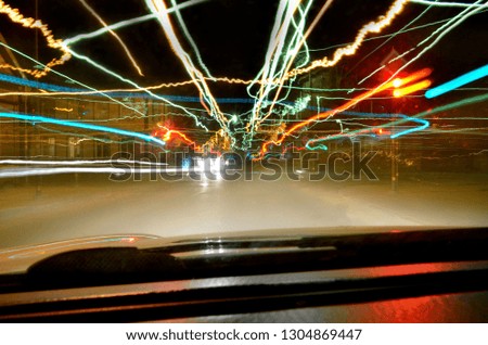 Abstract shot of city and traffic lights from inside of the car. Concept of speed, fast motion and time traveling