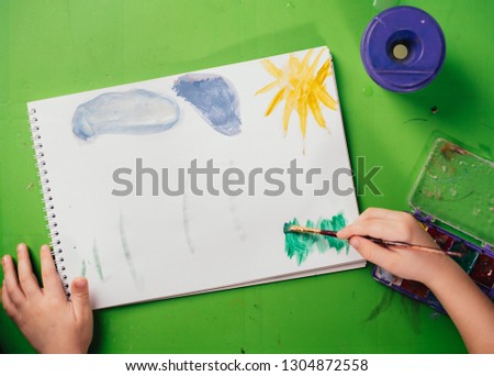 boy paints in his room