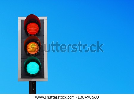 traffic lights against a vibrant blue sky (copy-space ready for your design)