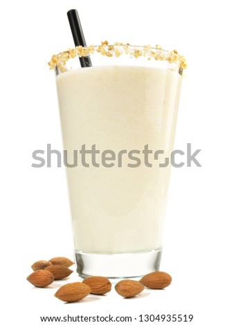 Almond Milkshake with Almonds in a Glass. Isolated on white Background.