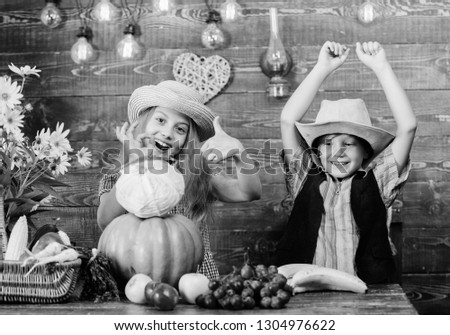 Elementary school fall festival idea. Autumn harvest festival. Children play vegetables wooden background. Kids girl boy wear hat celebrate harvest festival rustic style. Celebrate harvest holiday.