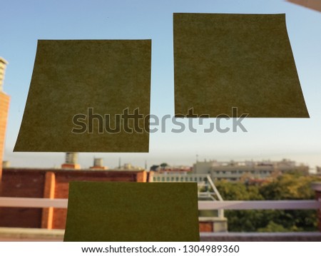 Sticky notes on the window or glass wall.