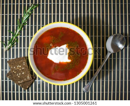 Picture a plate of borscht. Russian, Ukrainian, Belarusian, Polish, Lithuanian national dishes. Picture of a soup. Home made beet soup. 