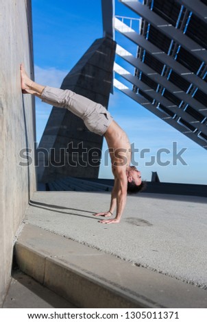 Man performing advanced yoga exercises and stretching to keep the body healthy