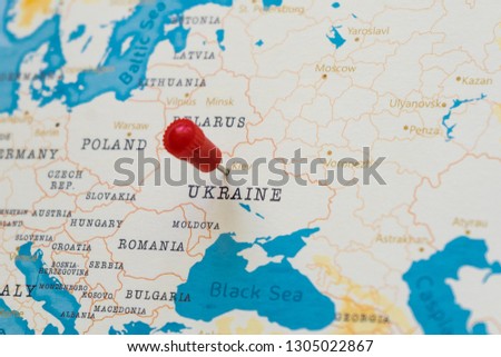 a pin on kiev, ukraine in the world map Royalty-Free Stock Photo #1305022867