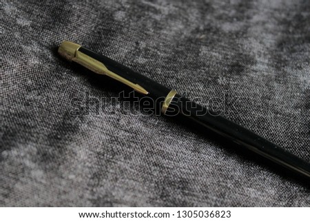 Pen on black texture 