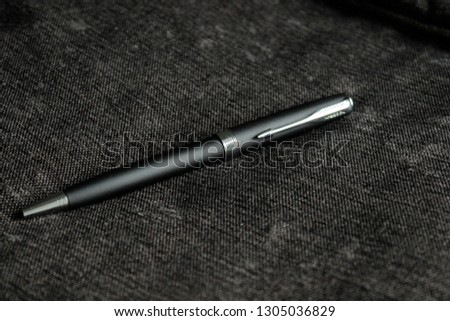 Pen on black texture 