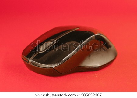 black computer mouse on a red background