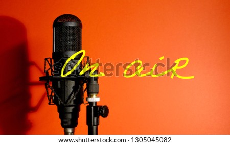 studio microphone. red background. inscription ON AIR