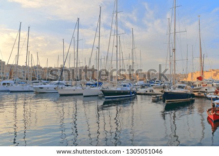 The photo was taken in the Marina of the island of Malta in the city of Birgu. The picture shows moored yachts in a quiet evening.