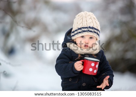 Sweet siblings, children having winter party in snowy forest. Kids friends rest outdoor at nature. Young brothers, boys, drinking tea from thermos. Hot drinks and beverage in cold weather