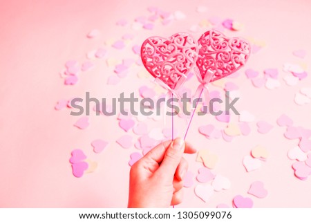 Closeup of two pink hearts on girl's hand. The concept of Valentine Day, love
