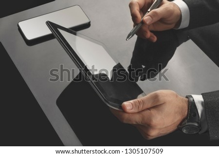 Businessman working in the office with communication equipments