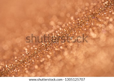 Gold abstract bokeh glitter texture background, filled with shiny gold glitter background. selective focus.