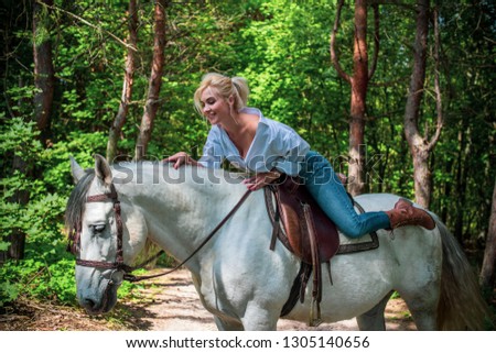 Spring - summer season, concept of hobby, Woman with a horse on a nature, relationship human and animals