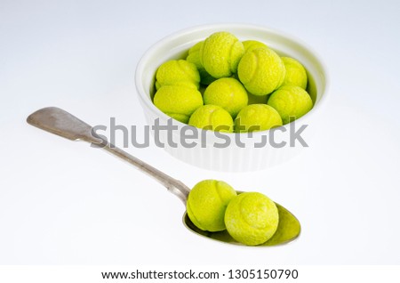Candies gum balls in shape of tennis balls. Studio Photo