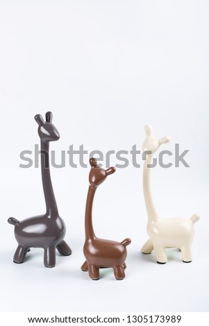 figurines with giraffes on white background