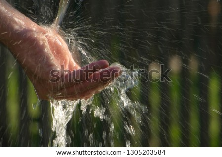 
man's hand under the water in the summer at the cottage.