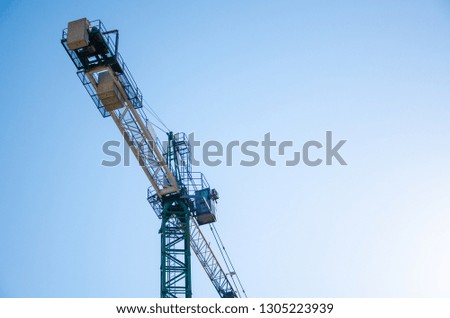 Construction crane on background blue sky