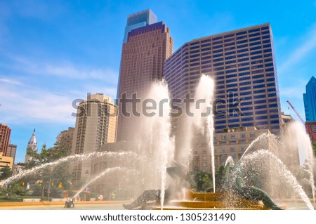 Logan Square Philadelphia, Pensilvania, USA with cityscape behind water from a fountain on a sunny summer day. Famous city's skyline downtown Philly.