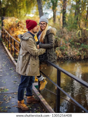 Two young travel couple walking on bridge