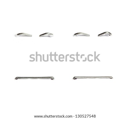 Set of different staples pushed into a piece of paper. Isolated on white background. Royalty-Free Stock Photo #130527548