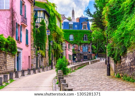 Street in quarter Montmartre in Paris, France. Cozy cityscape of Paris. Architecture and landmarks of Paris. Royalty-Free Stock Photo #1305281371