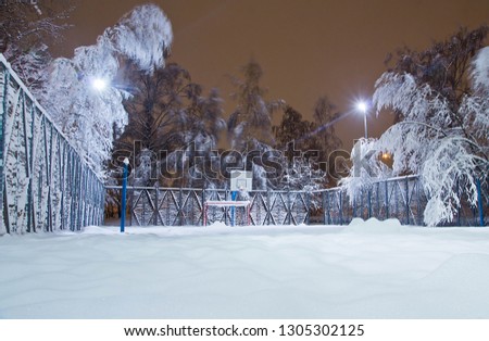 playground and trees in the evening winter park