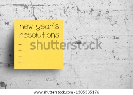 Sticky note on concrete wall, New year's resolutions