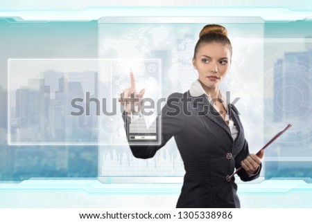 Beautiful business lady works with virtual graphic interface. Futuristic office